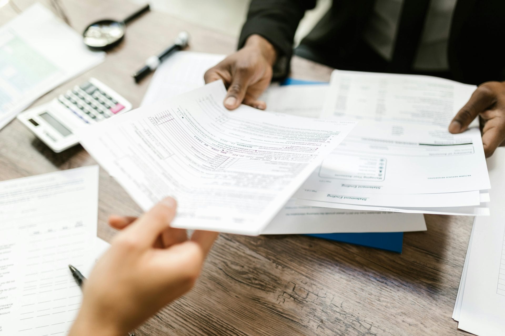 Insurance paperwork being reviewed at a desk.