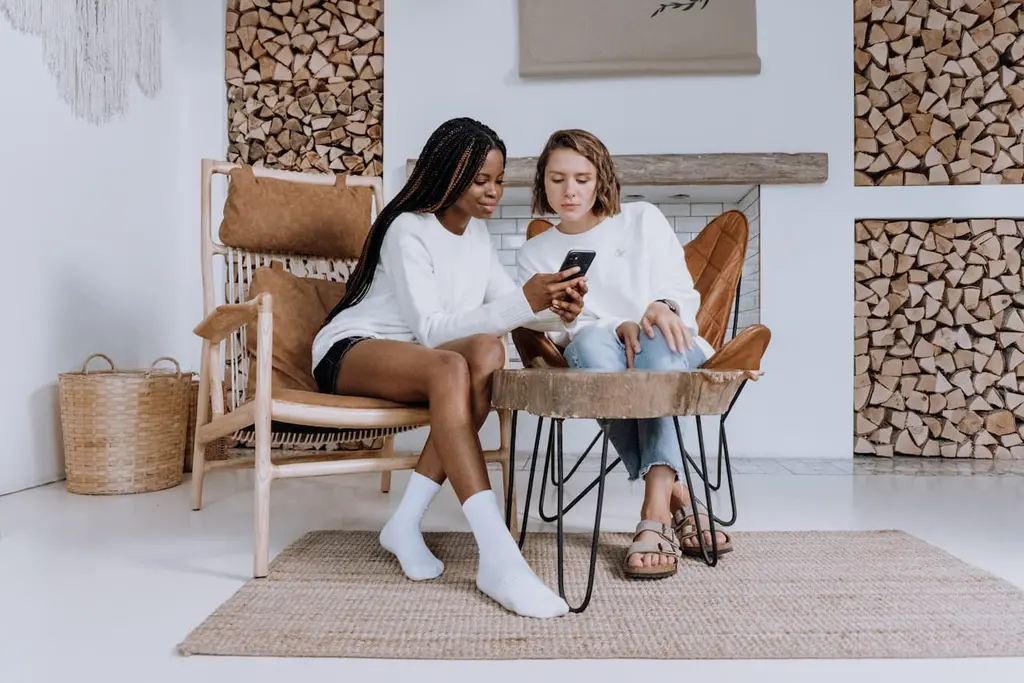 Two people reviewing the client portal on a smartphone together