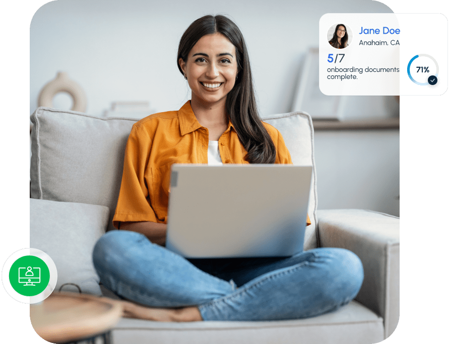 Smiling woman sitting on a couch using a laptop to complete onboarding documents in a client portal.